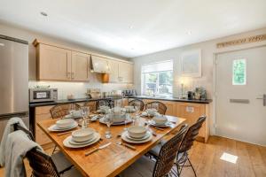 a kitchen and dining room with a wooden table and chairs at 3 Bed in Beadnell oc-44965 in Beadnell