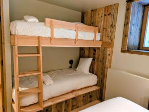 a bunk bed room with two bunk beds in it at Les Airelles by Lodji in Saint-Marcel +10 photos