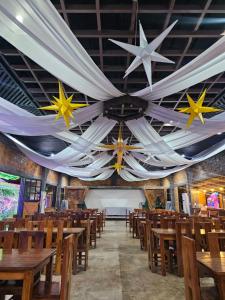 a dining room with wooden tables and a ceiling with stars at Alcasas Resort in Duero