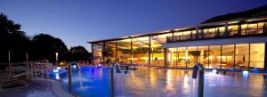 a large building with a pool in front of it at Biosphärenhotel Graf Eberhard bei der Therme Bad Urach in Bad Urach