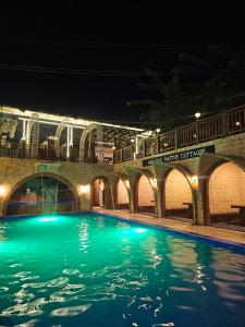 a swimming pool in front of a building at night at Alcasas Resort in Duero