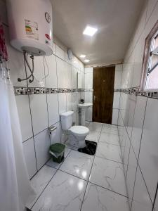 a white bathroom with a toilet and a sink at Marvira Barra del Chuy in Xuí +16 photos
