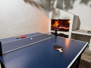 a ping pong table with a ping paddle and a fireplace at Marvira Barra del Chuy in Xuí