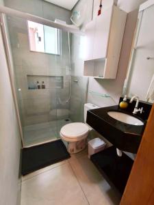 a bathroom with a shower and a toilet and a sink at Yama Hospedagem e Moradia in Paranavaí +104 photos