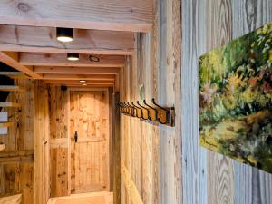 a room with wooden walls and a painting on the wall at Les Framboisiers by Lodji in Saint-Marcel +15 photos