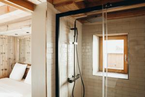 a shower in a room with a bed and a window at Les Framboisiers by Lodji in Saint-Marcel