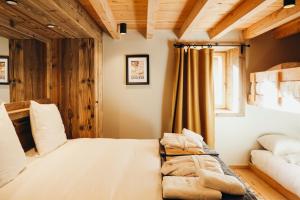 a bedroom with a large bed and a couch at Les Framboisiers by Lodji in Saint-Marcel