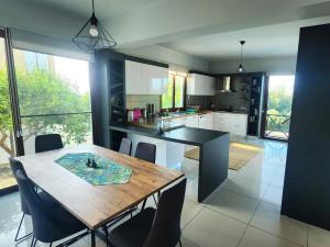 a kitchen with a wooden table and chairs in it at Villa Amazing by HolidayKeys in Kyrenia