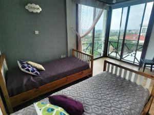 a bedroom with two beds and a large window at Villa Amazing by HolidayKeys in Kyrenia