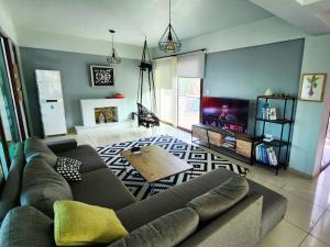 a living room with a couch and a table at Villa Amazing by HolidayKeys in Kyrenia