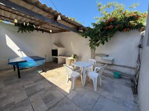 a patio with a table and two chairs and a bed at Marvira Barra del Chuy in Xuí