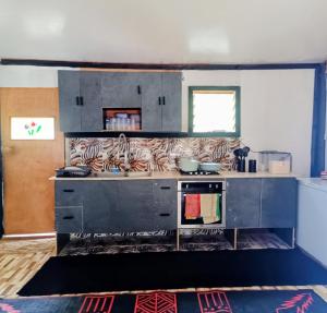 a kitchen with a stove and a counter top at LOwayalailaiSTAY in Wayasewa Island