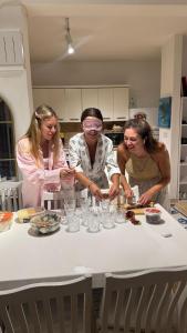 a group of three women standing around a table at Feraye Villas in Kaş +63 photos