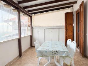 a white table and chairs on a balcony at M274 - Marcelli, comodo quadrilocale vista mare con terrazzo in Marcelli