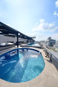 a large swimming pool on the roof of a building at Executive 2BHK in Zeta Mall in Islamabad
