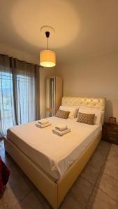 a bedroom with a large bed with two towels on it at Babis House in Pelekas