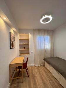 a bedroom with a bed and a desk and a table at Casa Luxemburgo in Torrevieja +23 photos