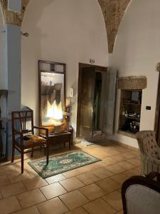 a living room with a table and a chair at Zen Palazzo Storico in Alliste