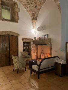 a living room with a couch and a fireplace at Zen Palazzo Storico in Alliste