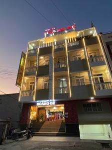 a large building with lights on top of it at HOÀNG ĐẾ motel in Chau Doc