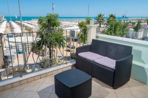 a balcony with a bench and a view of the ocean at Hotel Lido in Gabicce Mare