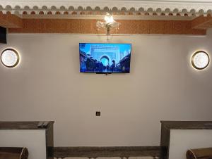 a room with a flat screen tv on the wall at Dar AWRABIA in Fez