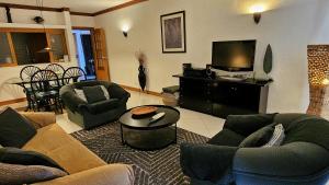 a living room with two couches and a television at Tivoli Apt8 with Pool&Garage in Vilamoura