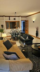 a living room with two couches and a table at Tivoli Apt8 with Pool&Garage in Vilamoura +14 photos
