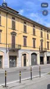 a large yellow building on a city street at Dante 12 Flat in Cremona