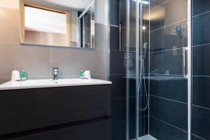 a bathroom with a sink and a shower at Auberge de la Paix in Briançon