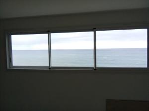a window in a room with a view of the ocean at Super boss in Saint-Benoît +26 photos