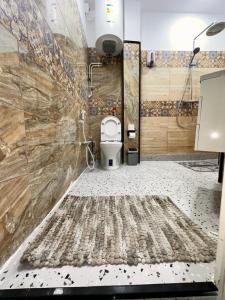 a bathroom with a white toilet in a room at Dar el bahdja in Sidi MʼHamed +58 photos
