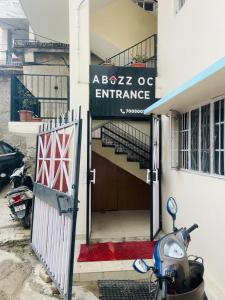 a scooter parked in front of a building with a entrance at Abuzz Oxfordcaps Simla in Shimla