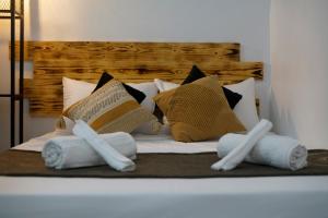a bed with towels and pillows on it at Dar el bahdja in Sidi MʼHamed
