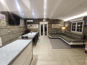 a living room with a couch and a table at NetosResidence in Freixo de Baixo