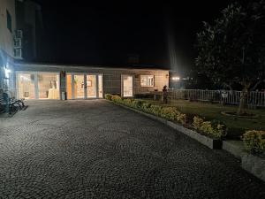 a building at night with a cobblestone street at NetosResidence in Freixo de Baixo