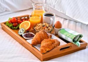 a tray of breakfast foods on a bed at Les Hirondelles Chanaz in Chanaz
