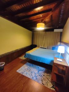 a bedroom with a blue bed and a wooden ceiling at NetosResidence in Freixo de Baixo