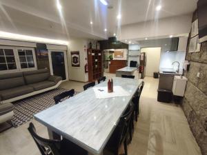 a large kitchen and living room with a large table at NetosResidence in Freixo de Baixo +7 photos