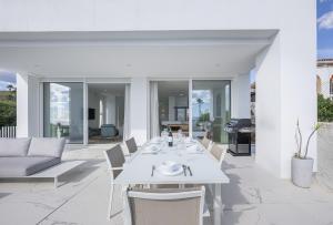 a white dining table and chairs on a patio at Villa Eliseo - private pool and sea views I 2400 in San Roque