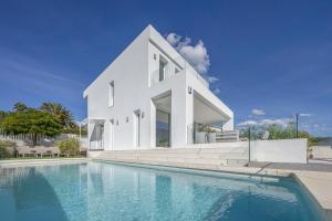 a white house with a swimming pool in front of it at Villa Eliseo - private pool and sea views I 2400 in San Roque
