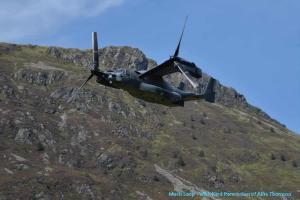 a helicopter is flying in front of a mountain at 2 Rhys Terrace in Machynlleth