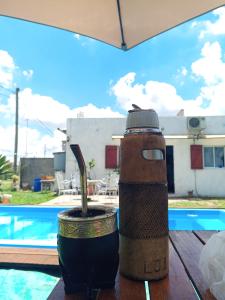 a drink dispenser sitting on a table next to a pool at La Marita in Gualeguay
