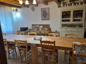 a kitchen and dining room with a wooden table and chairs at Casa 1885 in Belluno