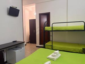 a room with two bunk beds and a television at Hotel San Paolo in Varazze