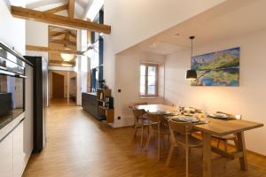 a kitchen and dining room with a wooden table and chairs at Adlerhorst -410- in Mittenwald