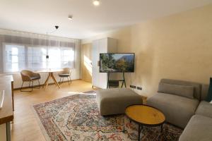 a living room with a couch and a table at Adlerhorst -410- in Mittenwald +23 photos