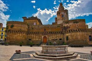 an old building with a fountain in front of it at Maddalena House in Vasto