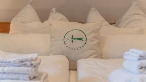 a white bed with a pillow with a picture of a plane at Pension Spreewald Lächeln - Apartment Kahnfahrt durch den Spreewald in Treppendorf