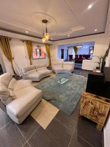 a large living room with couches and a table at Maison meublée Odza Yaoundé in Yaoundé